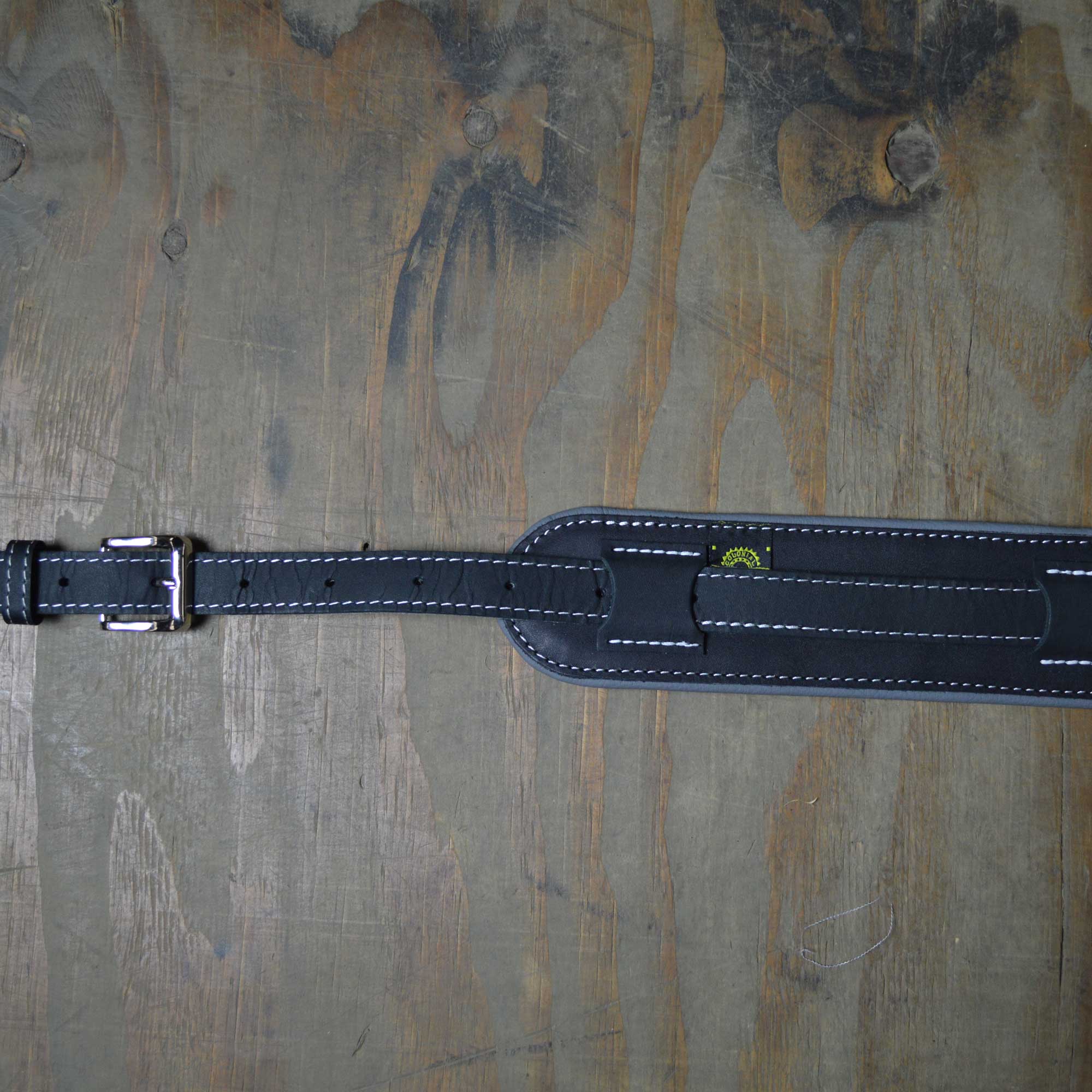 Vintage style guitar strap made with a topgrain leather top and an upholstery backing. Black & Grey